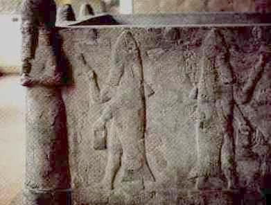 Ancient stone carving depicting constellations of the Mazzaroth, including figures such as a man holding a bow and an animal figure, etched in a weathered stone slab.