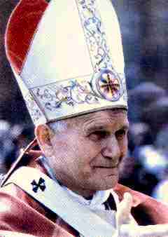 A mature male in ornate religious attire, including a tall, white mitre decorated with golden patterns and a red cape over a white robe, seen in profile.