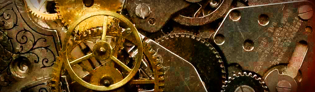 Close-up view of an intricate mechanical device featuring bronze gears and cogs, some adorned with patterns reminiscent of celestial mechanics and timekeeping principles.