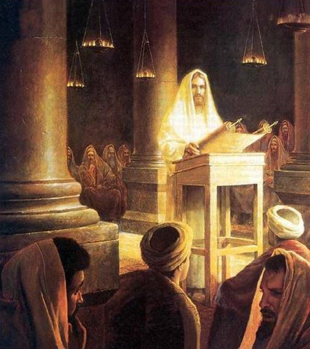 A historical painting depicting a figure teaching a congregation inside a dimly lit room with columns. The figure appears illuminated by a celestial glow, symbolizing divine presence. Listeners are gathered around, dressed in traditional ancient attire, engaging solemnly with the teachings.