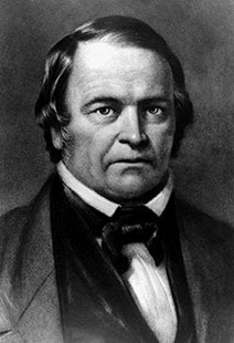 Black and white portrait of a mid-19th-century gentleman with a serious expression, wearing a dark coat, vest, and bowtie.