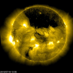 A scientific image capturing the sun, showcasing multiple solar flares and sunspots in a detailed high-energy solar observation. The sun's surface appears dynamic and active, emphasized by the bright yellow and orange hues.