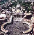 Aerial view of a large, circular building complex with an imposing dome at its center, surrounded by structured gardens and paths resembling celestial spheres.