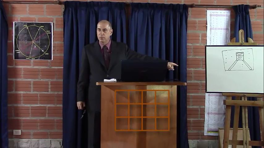 A man in a dark suit stands at a podium in a classroom setting, pointing to a visual aid with a circular diagram reminiscent of the Mazzaroth. Nearby, there's a whiteboard with a scientific illustration and charts aligned on the brick wall, underlined by celestial calculations.