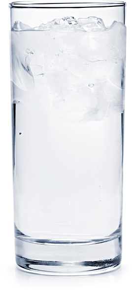 Tall clear glass filled to the brim with ice cubes, half-immersed in water.